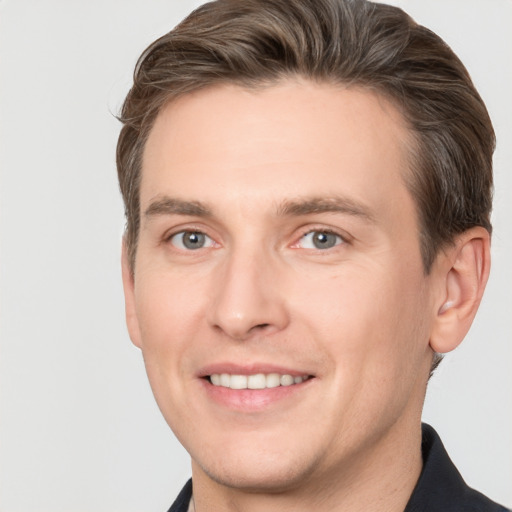 Joyful white adult male with short  brown hair and grey eyes