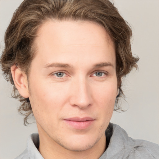 Joyful white adult male with medium  brown hair and grey eyes