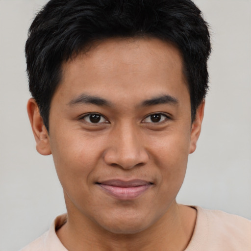 Joyful asian young-adult male with short  black hair and brown eyes