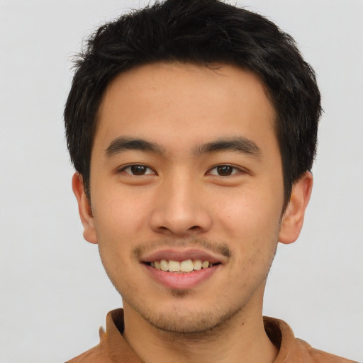 Joyful latino young-adult male with short  brown hair and brown eyes