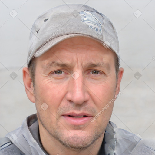 Joyful white adult male with short  brown hair and blue eyes