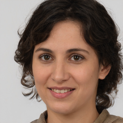 Joyful white adult female with medium  brown hair and brown eyes