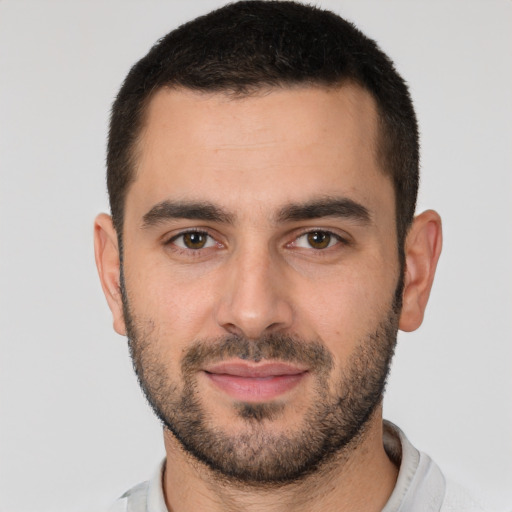 Joyful white young-adult male with short  brown hair and brown eyes