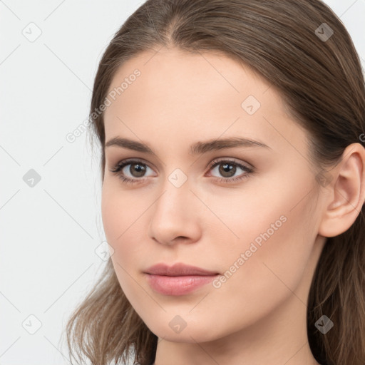 Neutral white young-adult female with long  brown hair and brown eyes