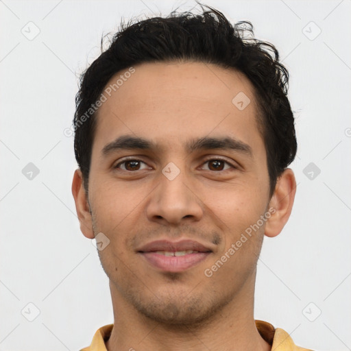 Joyful latino young-adult male with short  brown hair and brown eyes