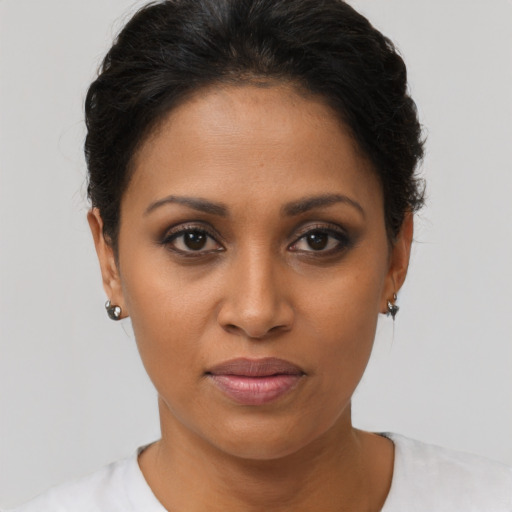 Joyful latino young-adult female with short  brown hair and brown eyes