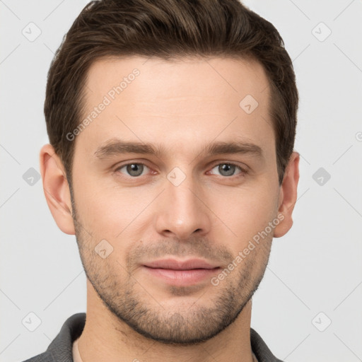 Joyful white young-adult male with short  brown hair and grey eyes