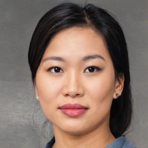 Joyful asian young-adult female with medium  black hair and brown eyes