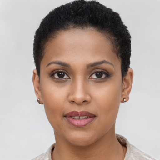 Joyful latino young-adult female with short  brown hair and brown eyes