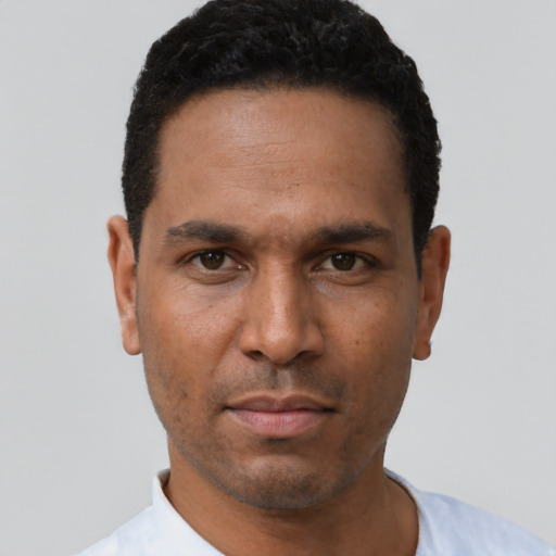 Neutral latino adult male with short  black hair and brown eyes