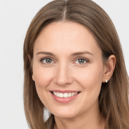 Joyful white young-adult female with long  brown hair and grey eyes