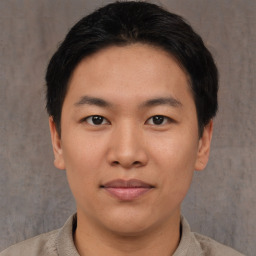 Joyful asian young-adult male with short  brown hair and brown eyes