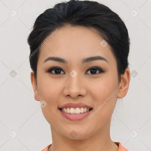 Joyful asian young-adult female with short  black hair and brown eyes