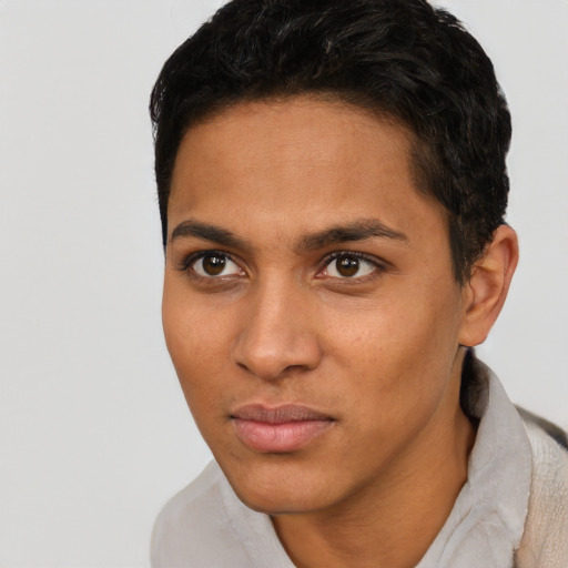Joyful latino young-adult male with short  brown hair and brown eyes