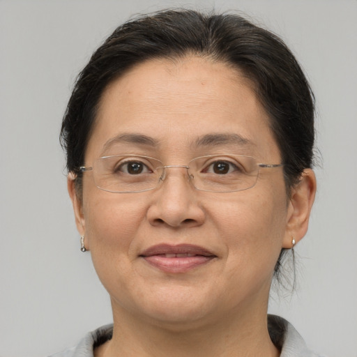 Joyful white adult female with medium  brown hair and brown eyes