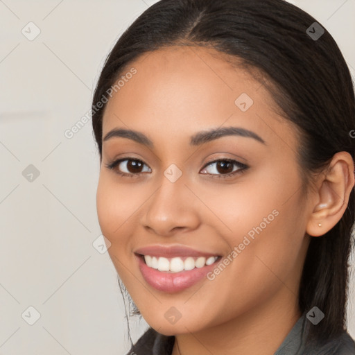 Joyful latino young-adult female with long  brown hair and brown eyes