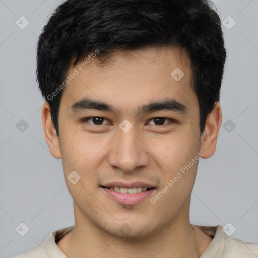 Joyful asian young-adult male with short  brown hair and brown eyes