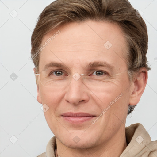 Joyful white adult male with short  brown hair and grey eyes