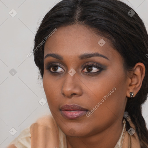 Joyful black young-adult female with long  brown hair and brown eyes