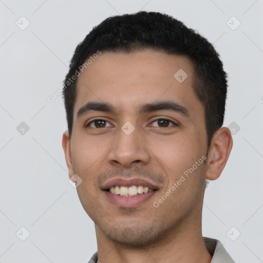 Joyful latino young-adult male with short  black hair and brown eyes