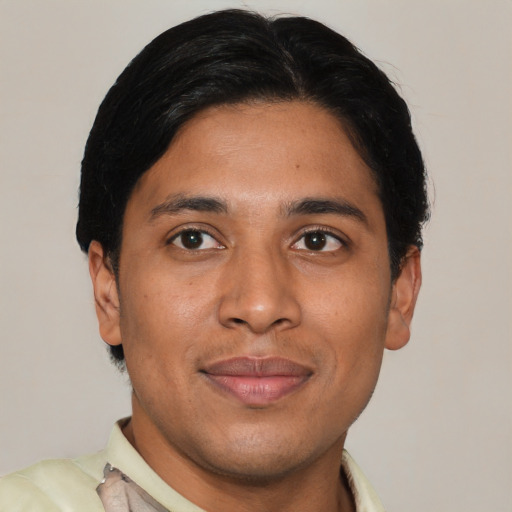 Joyful latino young-adult male with short  black hair and brown eyes