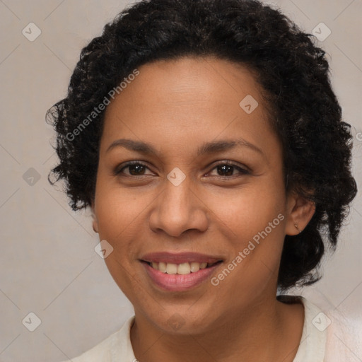 Joyful latino adult female with medium  brown hair and brown eyes