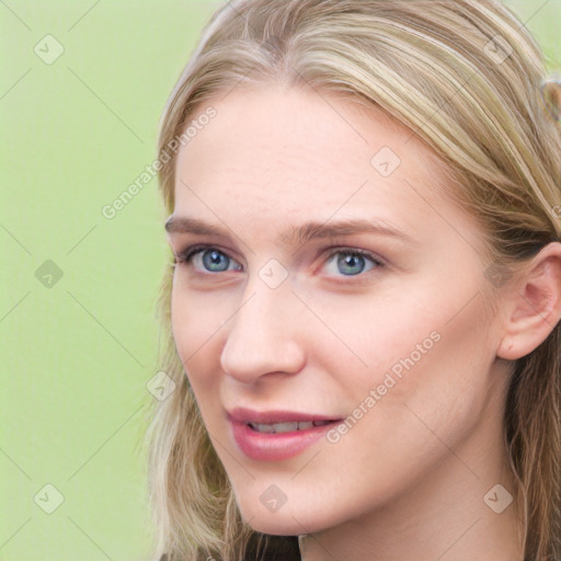 Joyful white young-adult female with long  brown hair and blue eyes