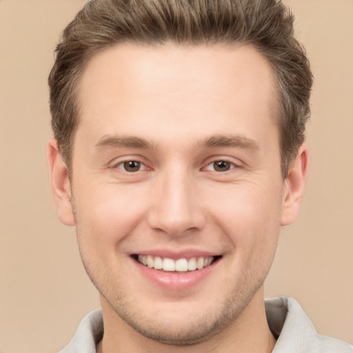 Joyful white young-adult male with short  brown hair and brown eyes