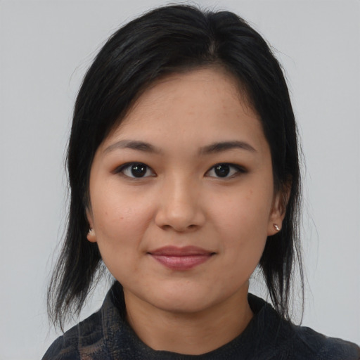 Joyful latino young-adult female with medium  black hair and brown eyes