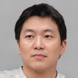 Neutral asian adult male with short  brown hair and brown eyes