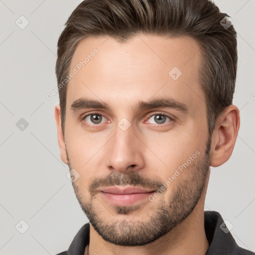 Joyful white young-adult male with short  brown hair and brown eyes