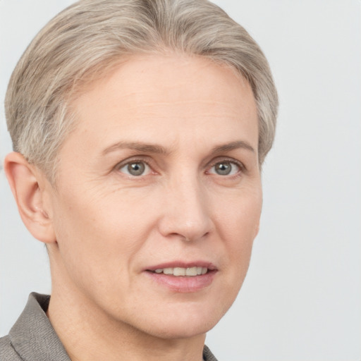 Joyful white adult female with short  brown hair and grey eyes