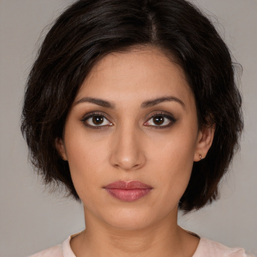 Joyful white young-adult female with medium  brown hair and brown eyes