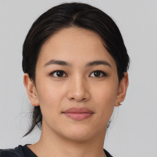 Joyful asian young-adult female with medium  brown hair and brown eyes