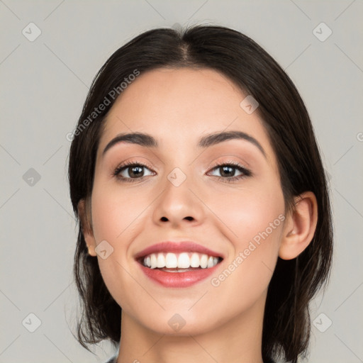 Joyful white young-adult female with medium  black hair and brown eyes