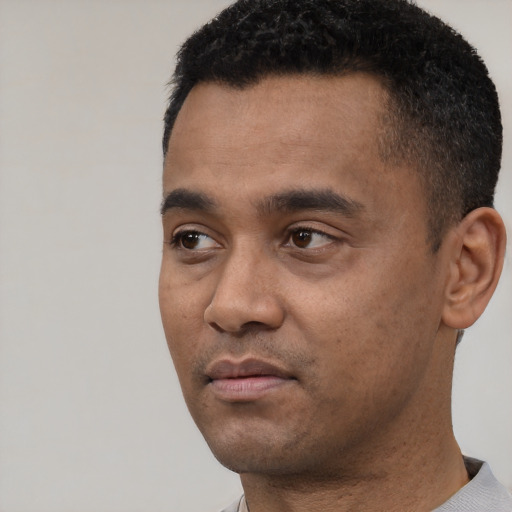 Neutral black young-adult male with short  black hair and brown eyes