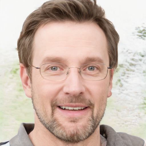 Joyful white adult male with short  brown hair and grey eyes