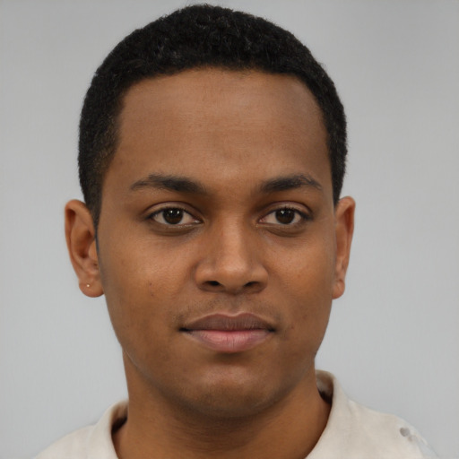 Joyful black young-adult male with short  black hair and brown eyes
