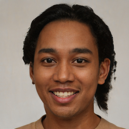 Joyful black young-adult male with short  black hair and brown eyes
