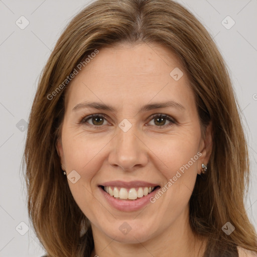 Joyful white adult female with long  brown hair and brown eyes