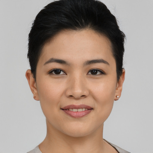 Joyful asian young-adult female with short  black hair and brown eyes