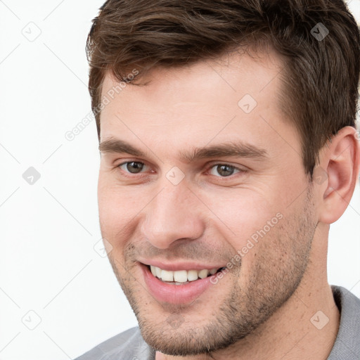 Joyful white young-adult male with short  brown hair and brown eyes