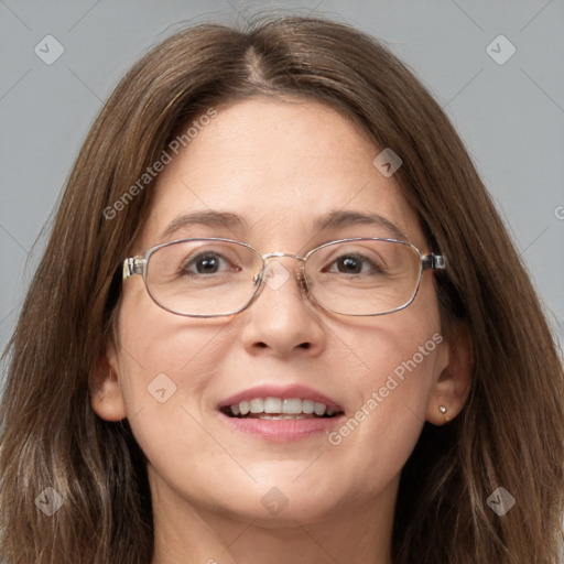 Joyful white adult female with long  brown hair and blue eyes