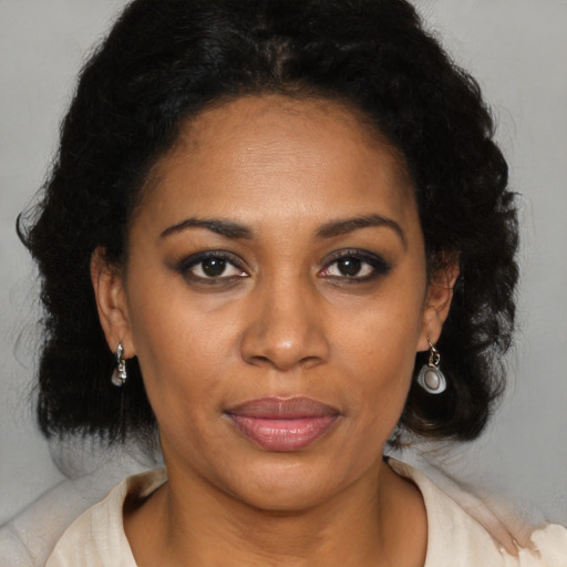 Joyful black adult female with medium  brown hair and brown eyes