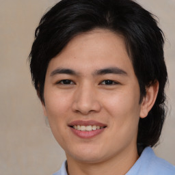 Joyful asian young-adult male with medium  brown hair and brown eyes