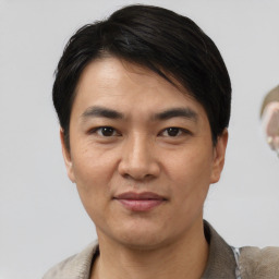 Joyful asian young-adult male with short  black hair and brown eyes