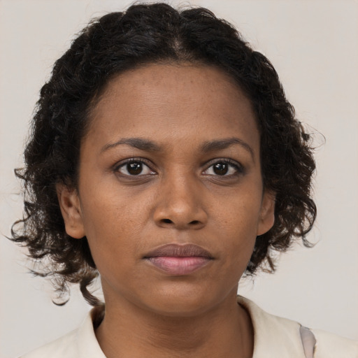 Neutral black young-adult female with medium  brown hair and brown eyes