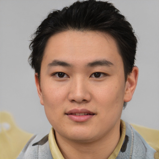 Joyful asian young-adult male with short  brown hair and brown eyes