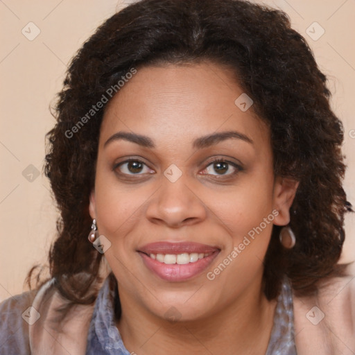 Joyful black young-adult female with long  brown hair and brown eyes