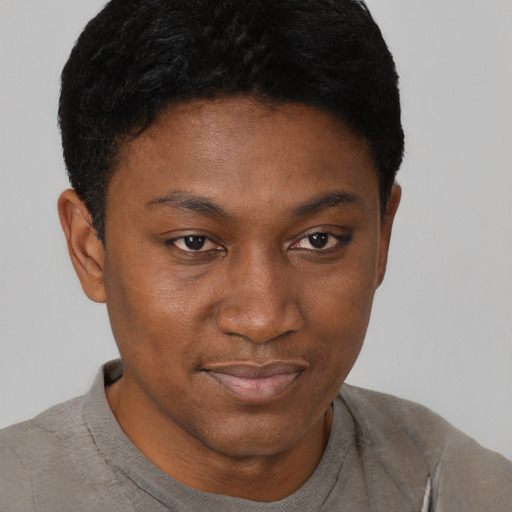 Joyful black young-adult male with short  brown hair and brown eyes